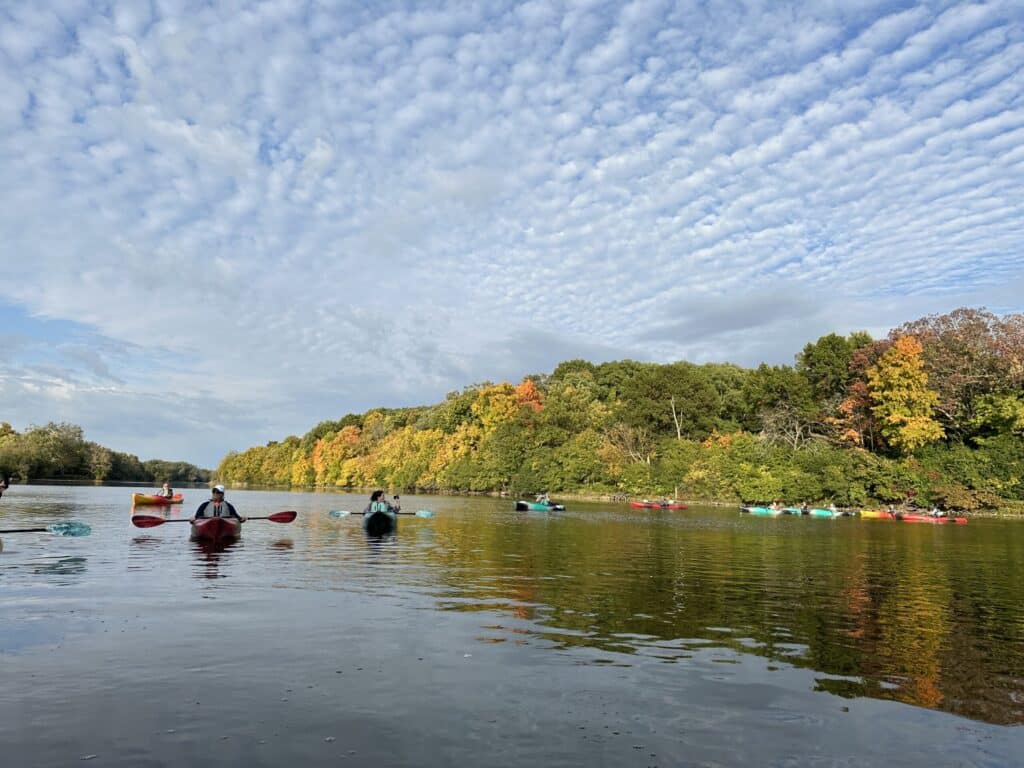 Best places to kayak near Chicago in fall with kayakers paddling the Fox River under colorful trees